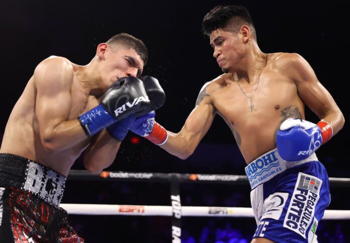 Emanuel Navarrete lands an uppercut during his boxing bout against Eduardo Baez