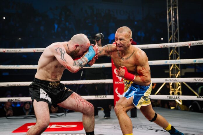 Gary Fox punches Jonno Chipchase during their bare-knuckle boxing bout at BKFC Manchester