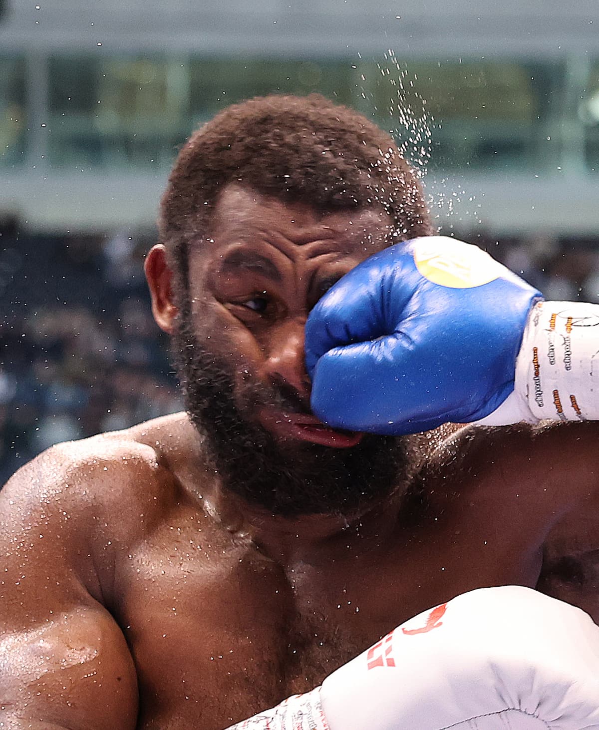 Cheavon Clarke gets punched during his boxing bout against Viddal Riley