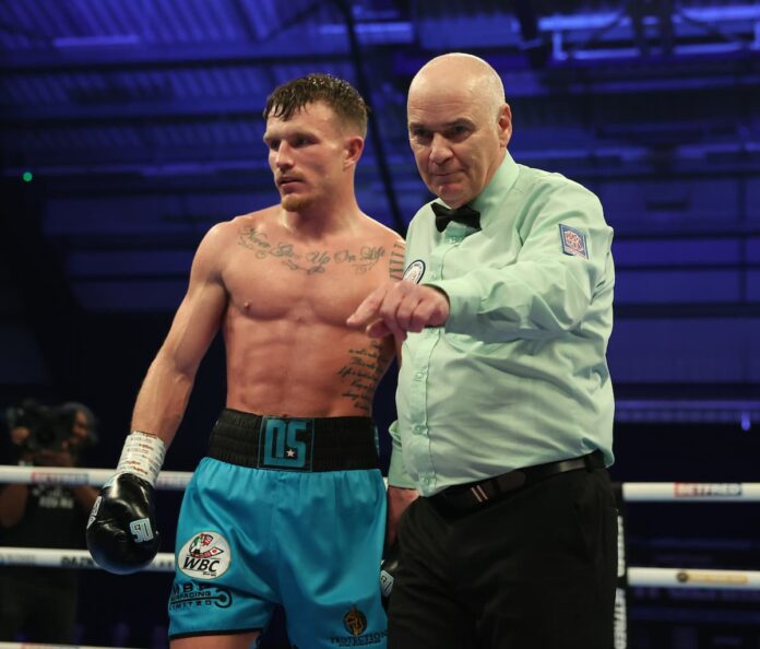 Dalton Smith gets a point deducted for a low blow during his boxing bout against Mathieu Germain in Sheffield, England