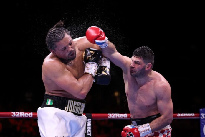 Filip Hrgovic punches Joe Joyce during their boxing bout in Manchester