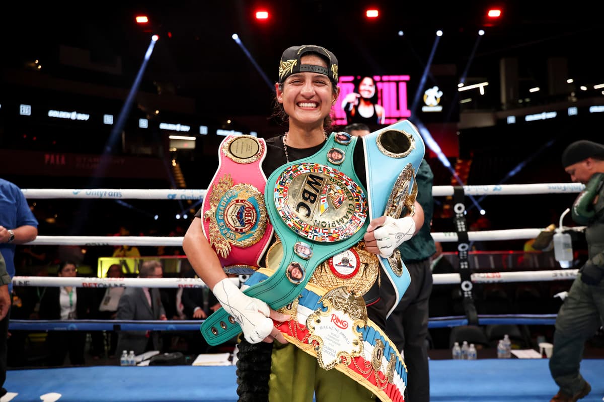 Gabriela Fundora with her championship belts celebrating victory over Marilyn Badillo
