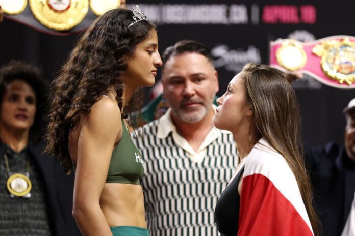 Gabriela Fundora and Marilyn Badillo face each other at the weigh-in ahead of their boxing bout in Oceanside, CA