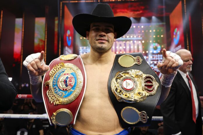 Gilberto 'Zurdo' Ramirez poses with his championship belts after his boxing bout against Chris Billam-Smith