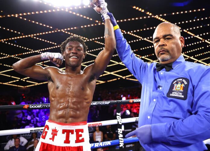 Referee Shawn Clark raises Jahi Tucker's hand after his boxing match victory over D'Andre Smith at Madison Square Garden