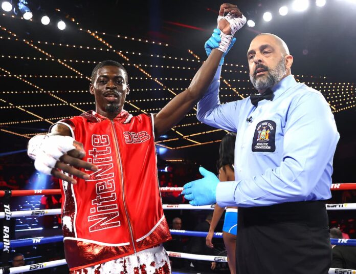 Referee Sparkle Lee raises Kelvin Davis' hand in victory after his boxing bout