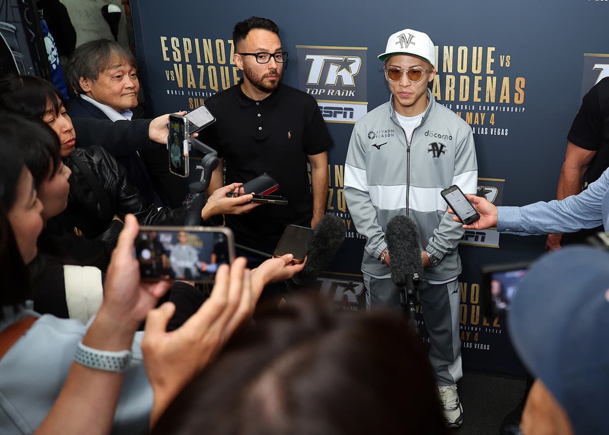 Naoya Inoue speaks to a group of reporters during a media scrum at a workout ahead of his fight against Ramon Cardenas