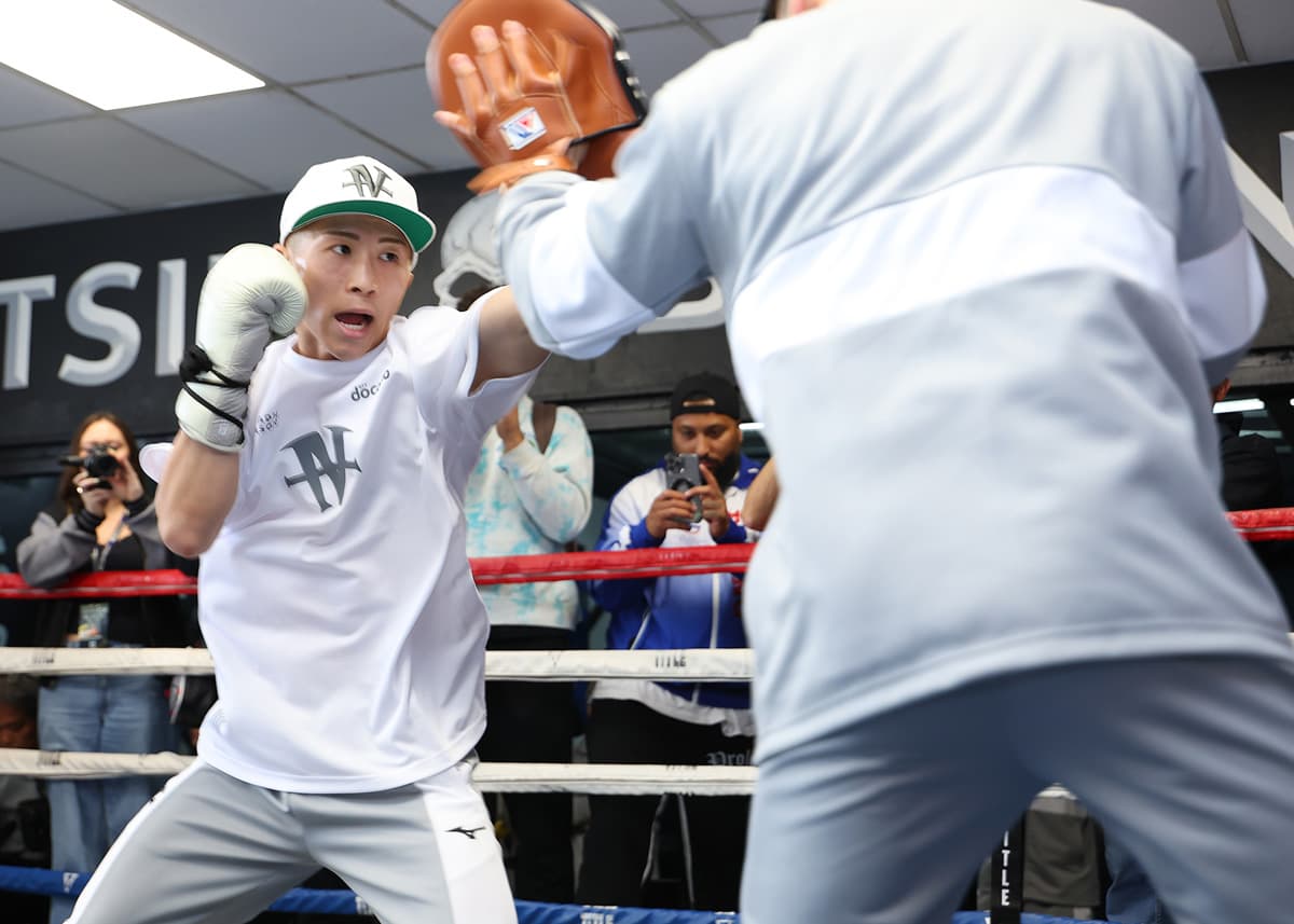 Naoya Inoue punches mitts during a media workout