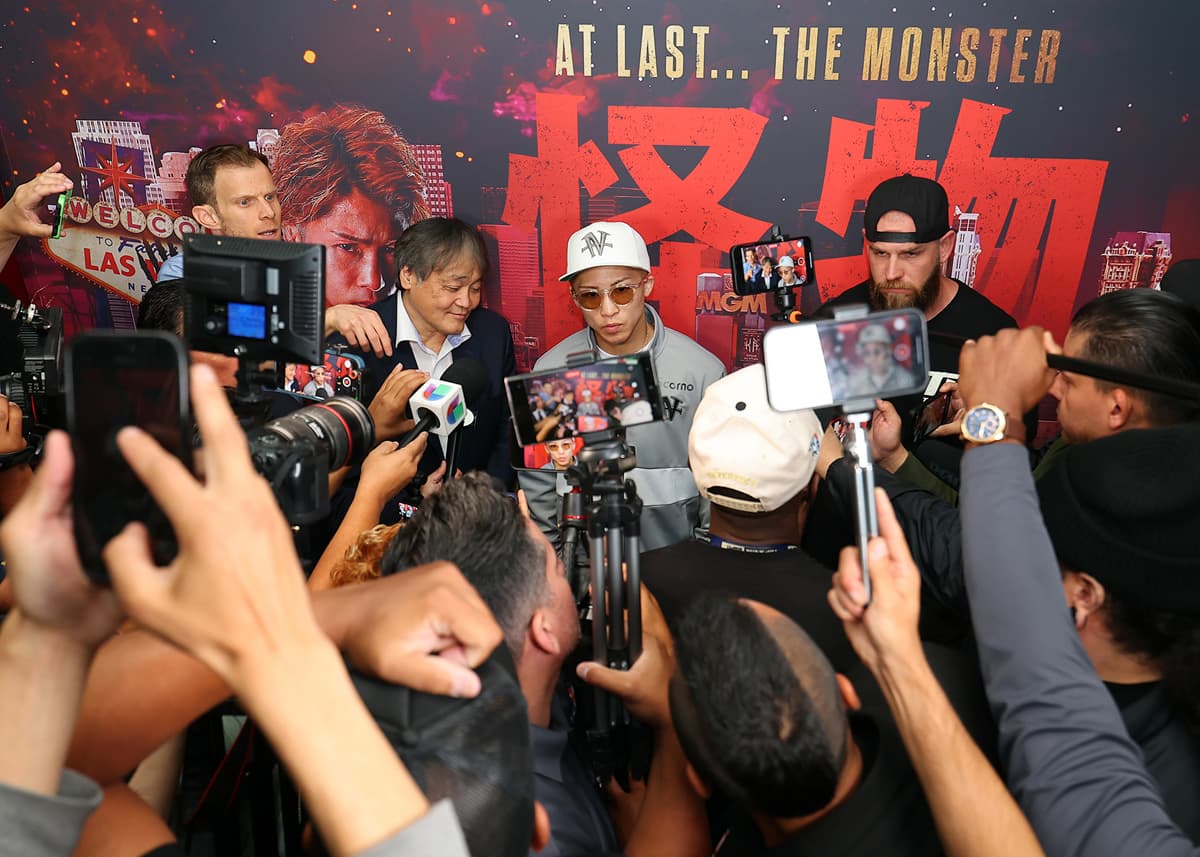 Naoya Inoue speaks to a group of reporters during a media scrum at a workout ahead of his fight against Ramon Cardenas