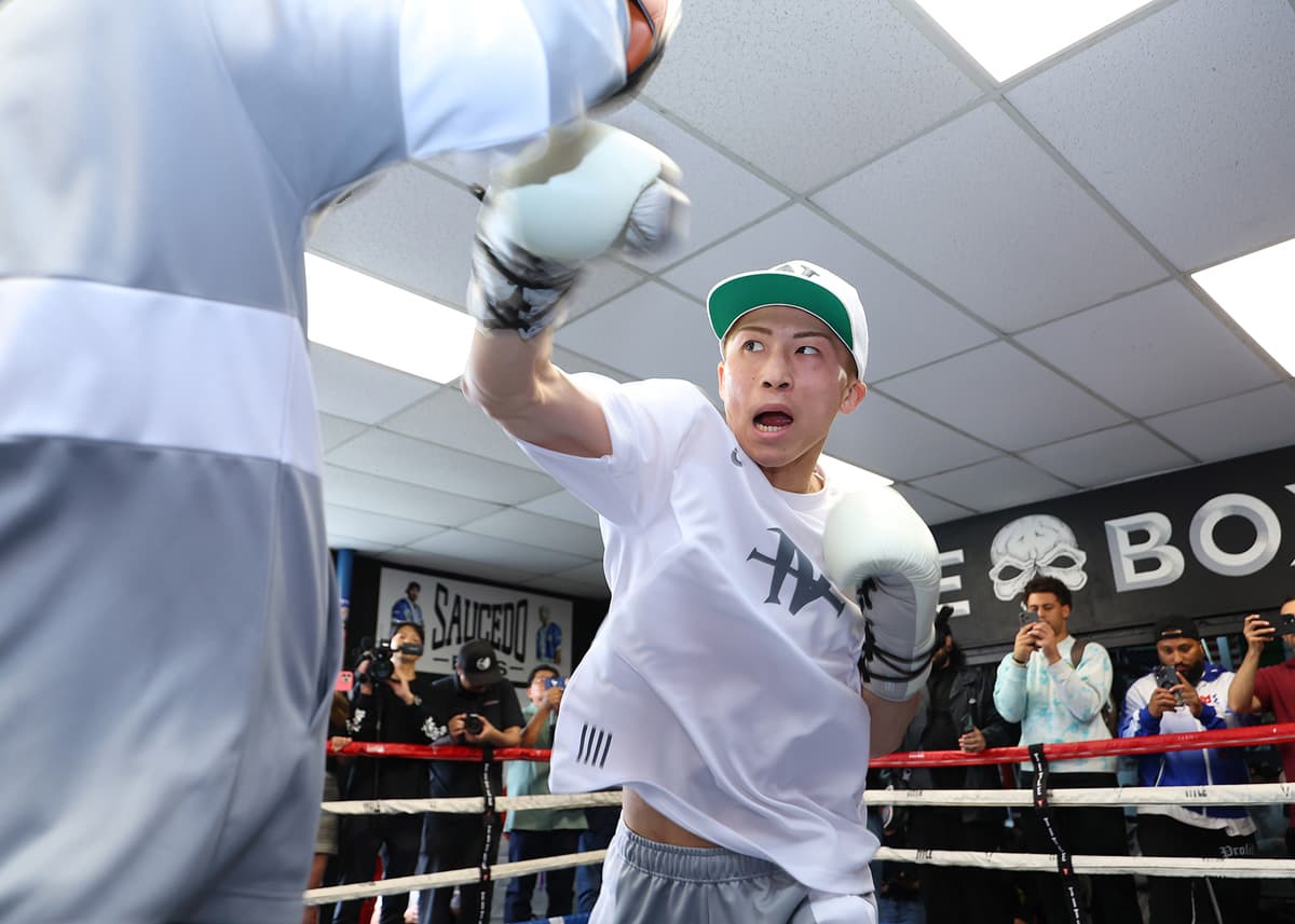 Naoya Inoue punches mitts during a media workout