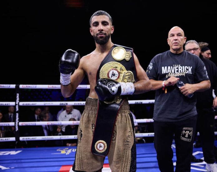 Shabaz Masoud poses with his championship belt after his boxing bout against Jose Sanmartin