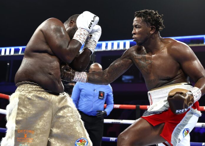 Brandon Moore punches Robert Simms during their boxing bout
