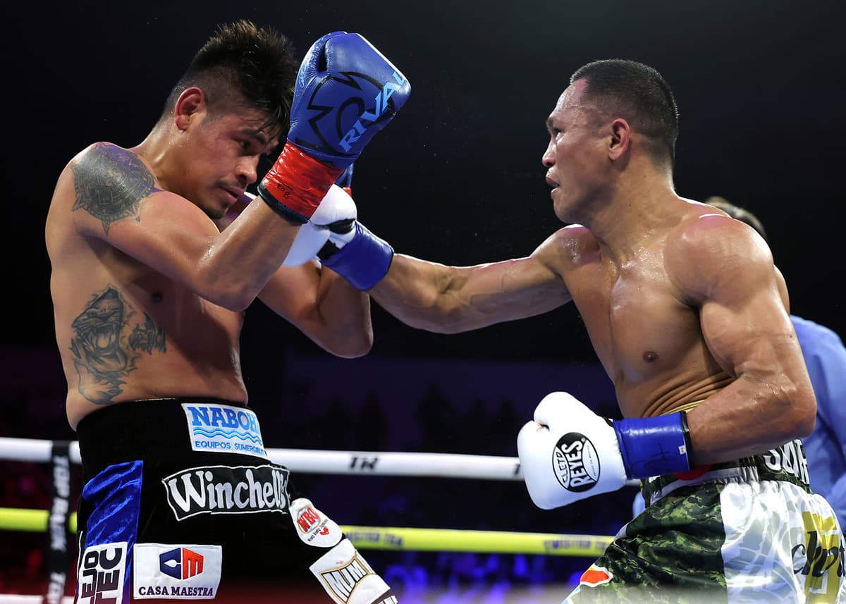 Charly Suarez punches Emanuel Navarrete during their boxing bout at Pechanga Arena San Diego