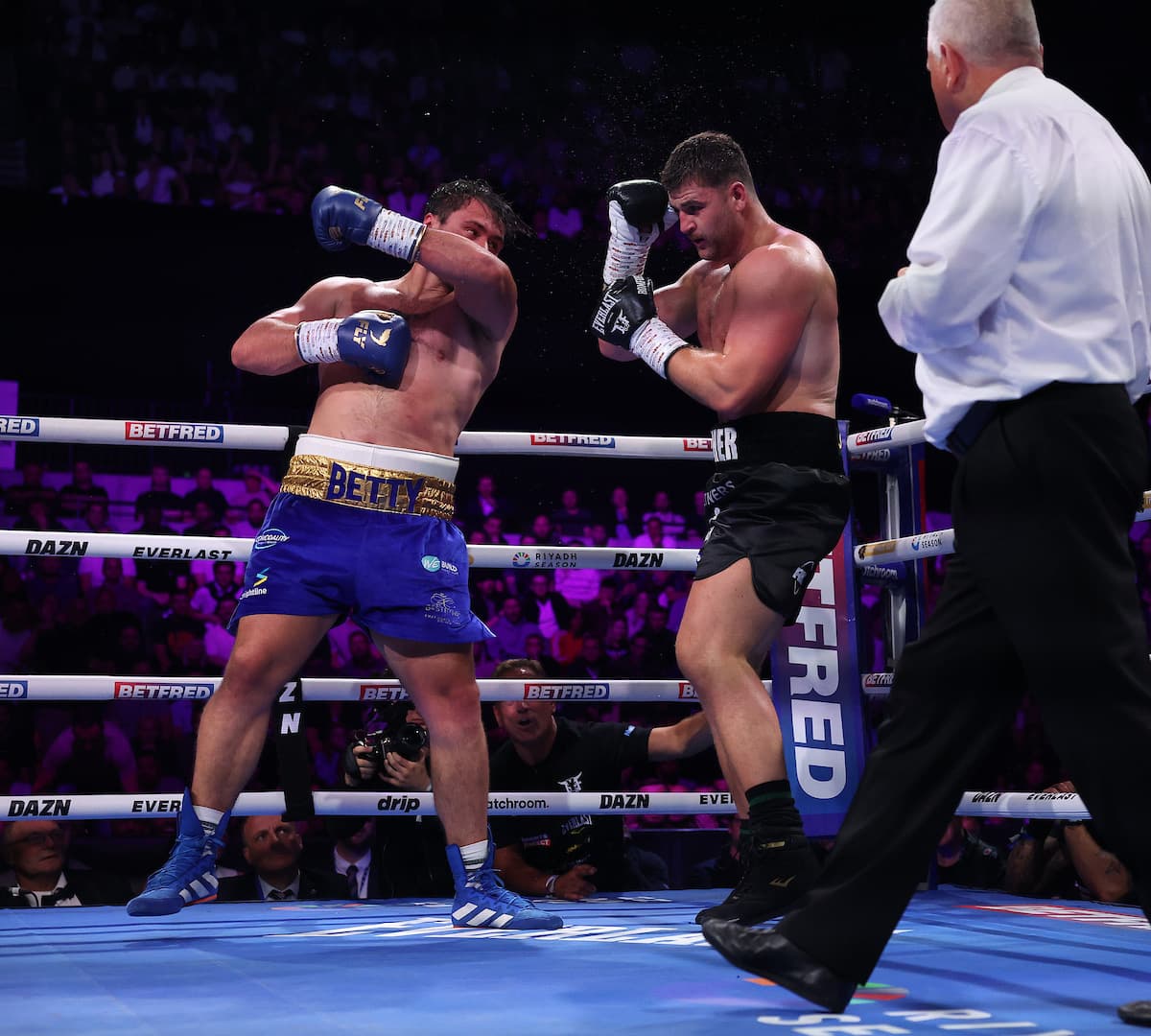 David Allen punches Johnny Fisher during their boxing rematch in London