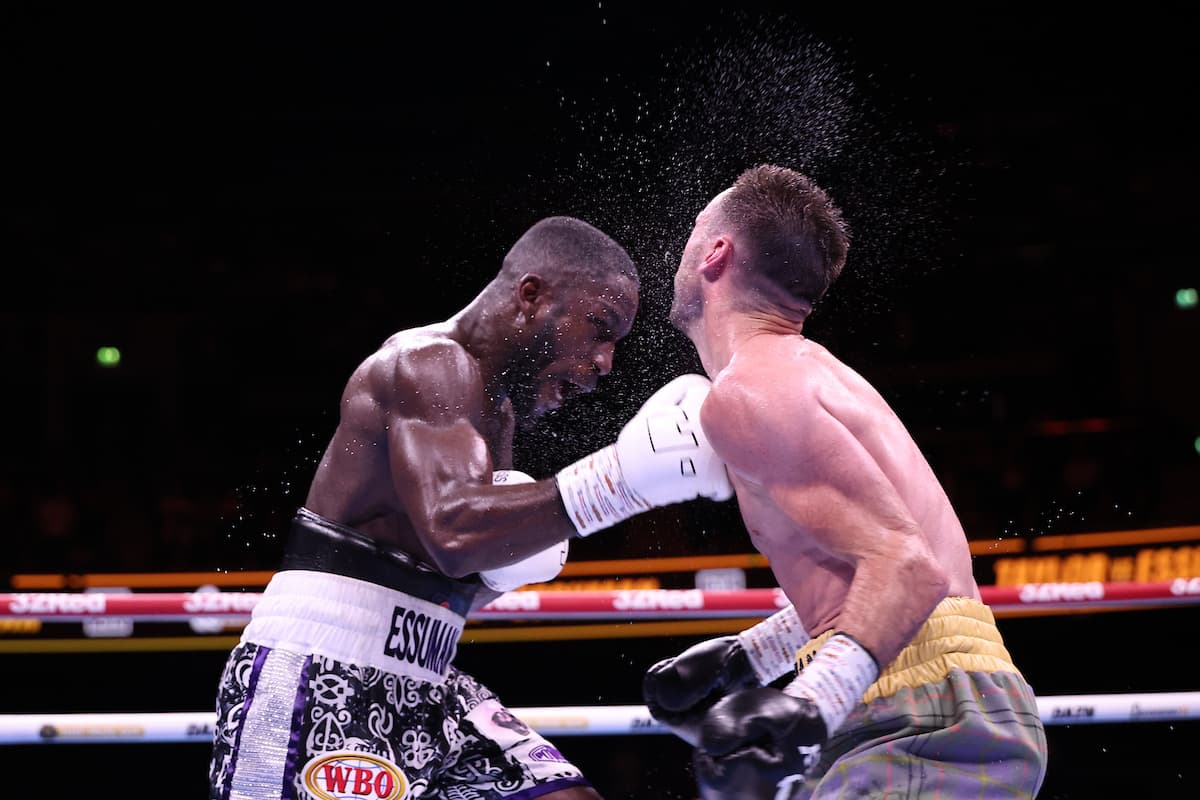 Ekow Essuman punches Josh Taylor during their boxing bout in Glasgow, Scotland