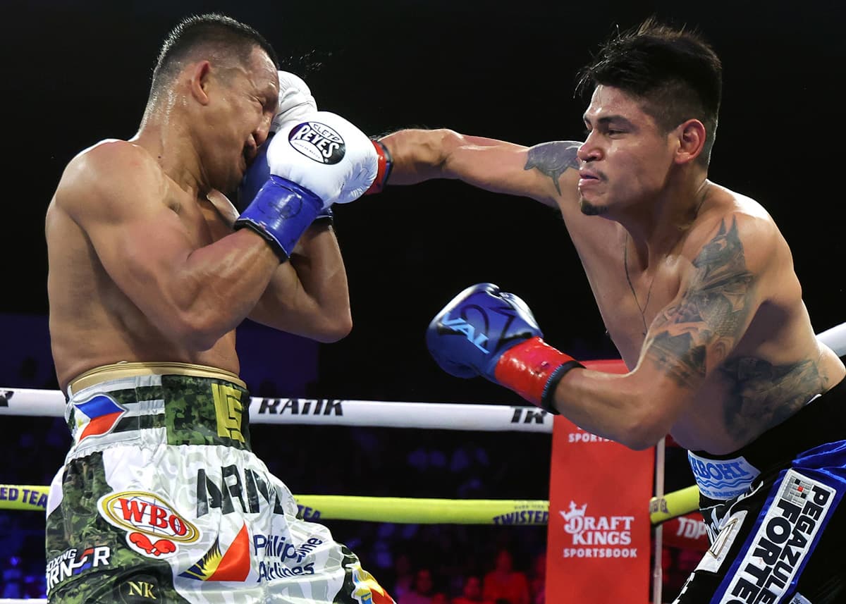Emanuel Navarrete punches Charly Suarez during their boxing bout at Pechanga Arena San Diego