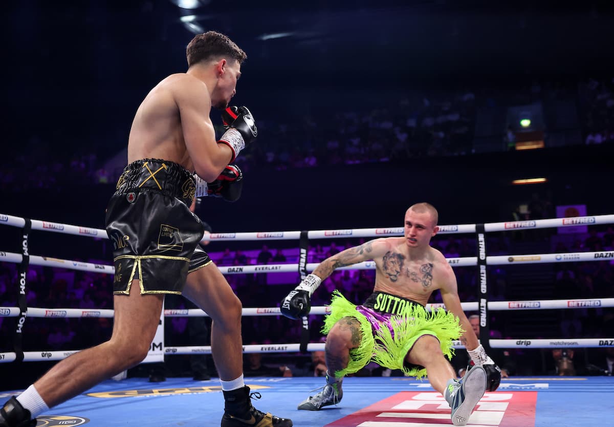 George Liddard knocks down Aaron Sutton during their boxing bout in London