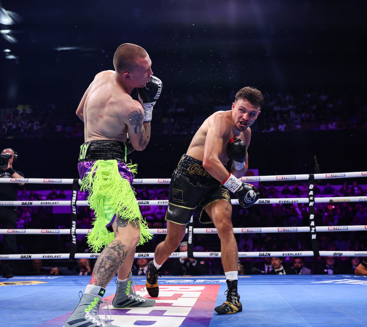George Liddard punches Aaron Sutton during their boxing bout in London