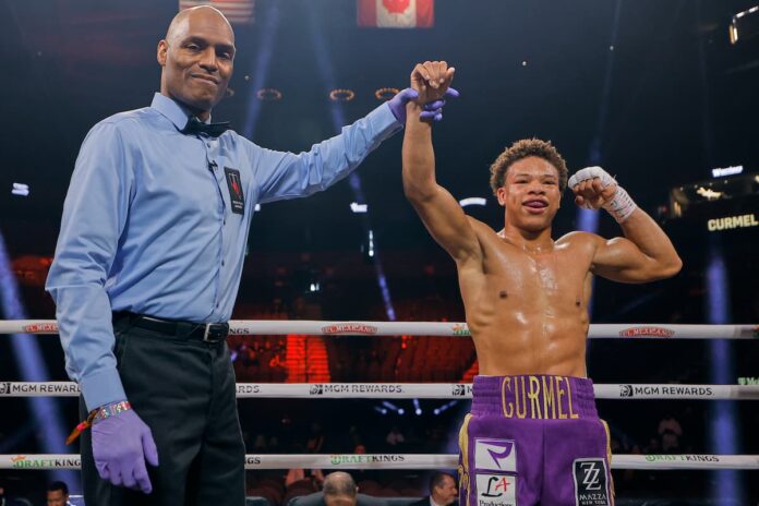 Referee Harvey Dock raises Curmel Moton's hand in victory over Frank Zaldivar after their boxing match in Las Vegas