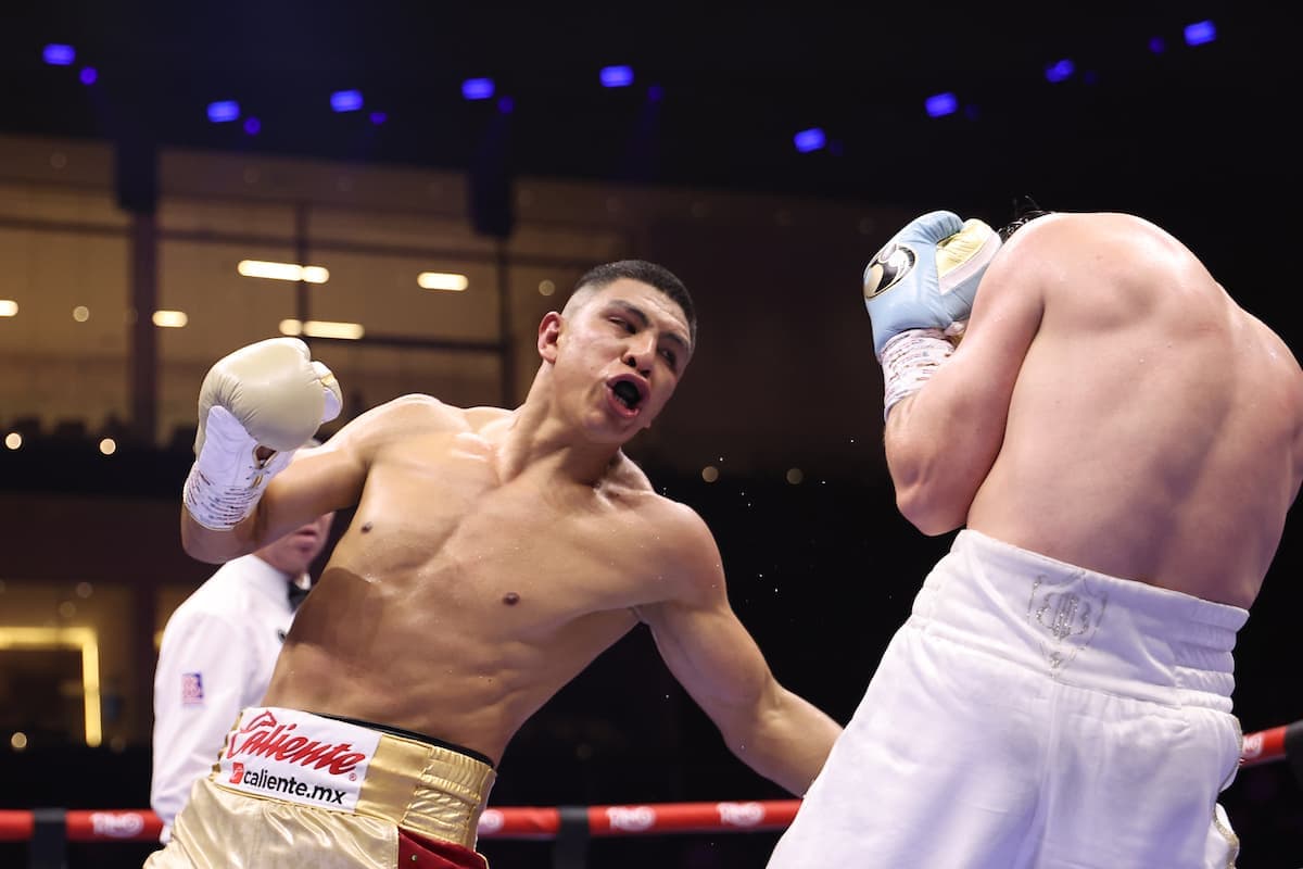 Jaime Munguia throws a body punch during his bout against Bruno Surace