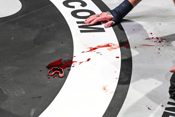 Mouthguard with blood on the canvas of a boxing ring during BKFC Knucklemania IV
