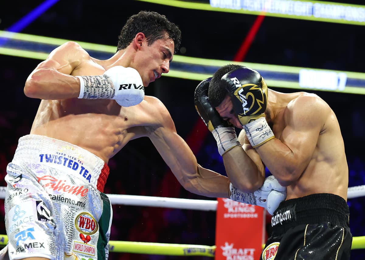 Rafael Espinoza punches Edward Vazquez during their boxing bout in Las Vegas