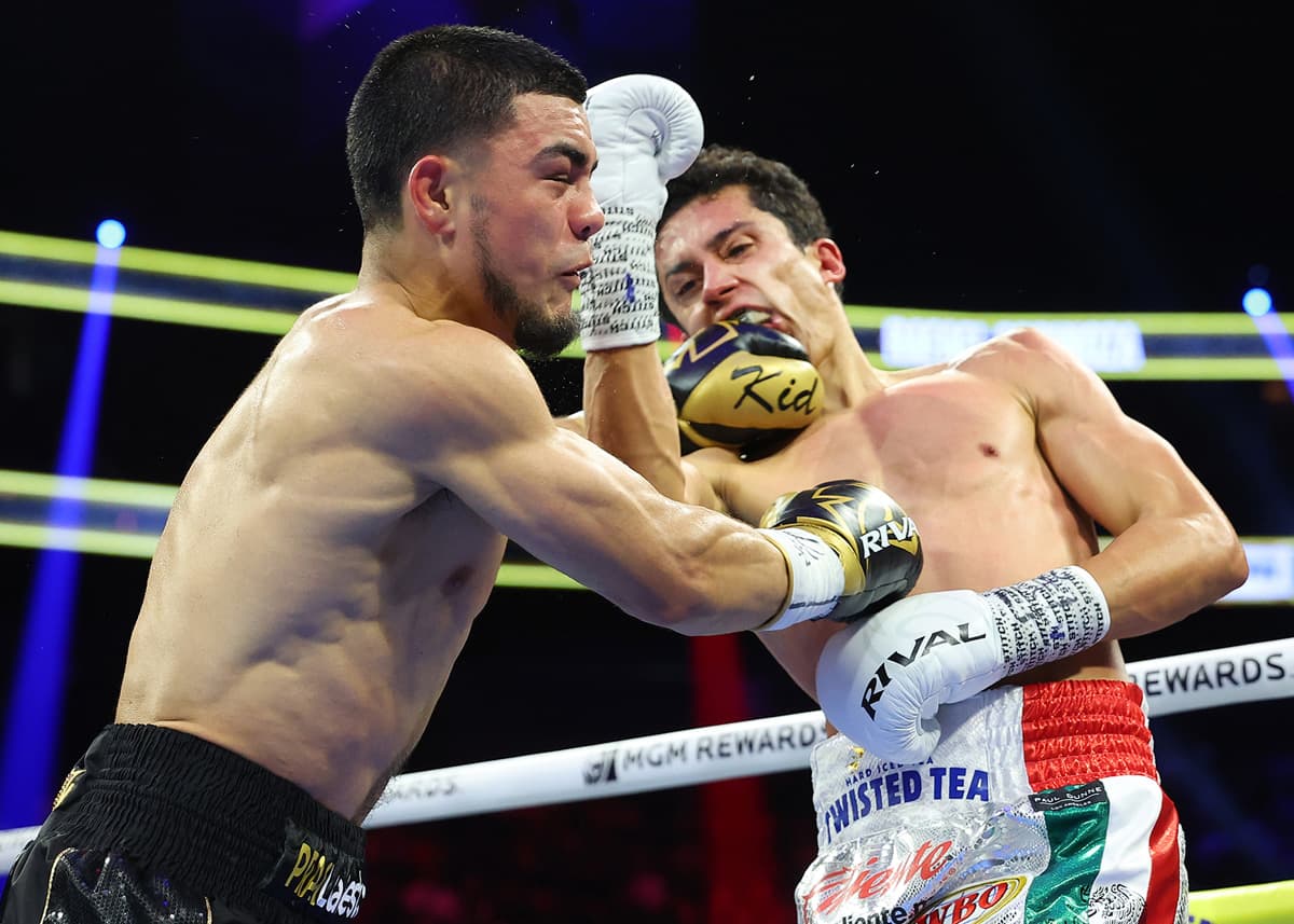 Rafael Espinoza throws an uppercut during his bout against Edward Vazquez
