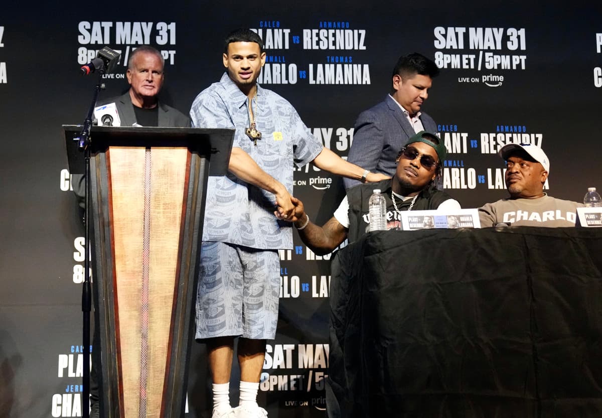 Rolando Romero and Jermall Charlo shake hands during a PBC doubleheader press conference in Los Angeles