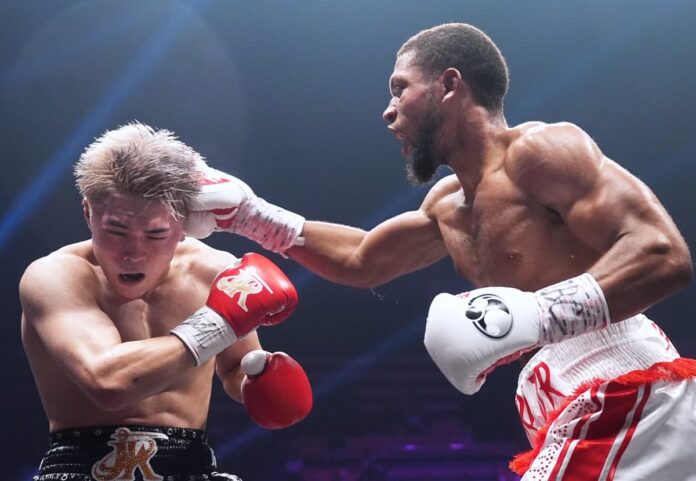 Brian Norman Jr punches Jin Sasaki during their boxing bout in Tokyo
