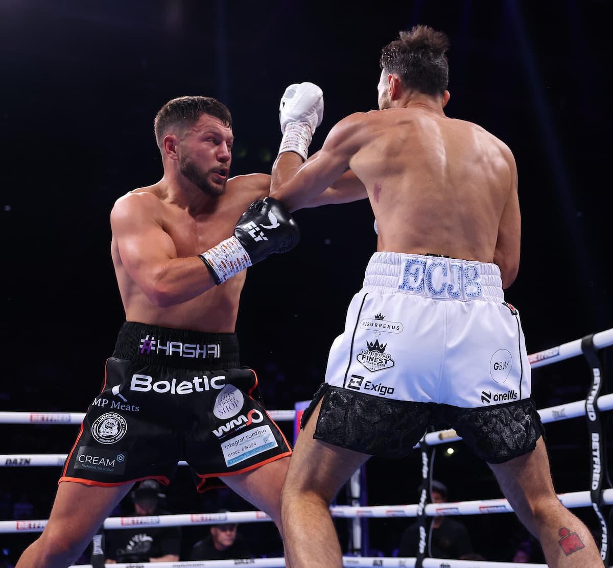 Conah Walker punches Liam Taylor during their boxing bout in Birmingham, England