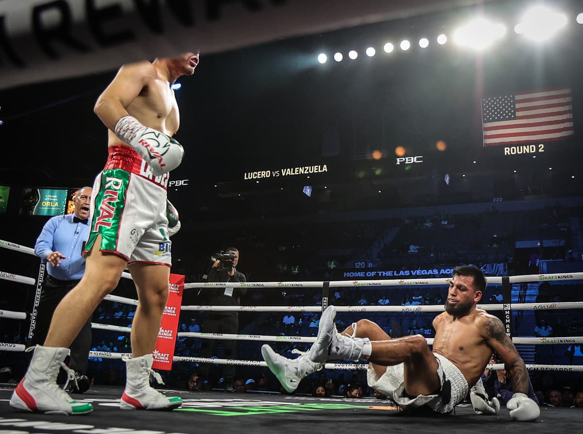 Isaac Lucero knocks down Luis Omar Valenzuela during their boxing bout in Las Vegas