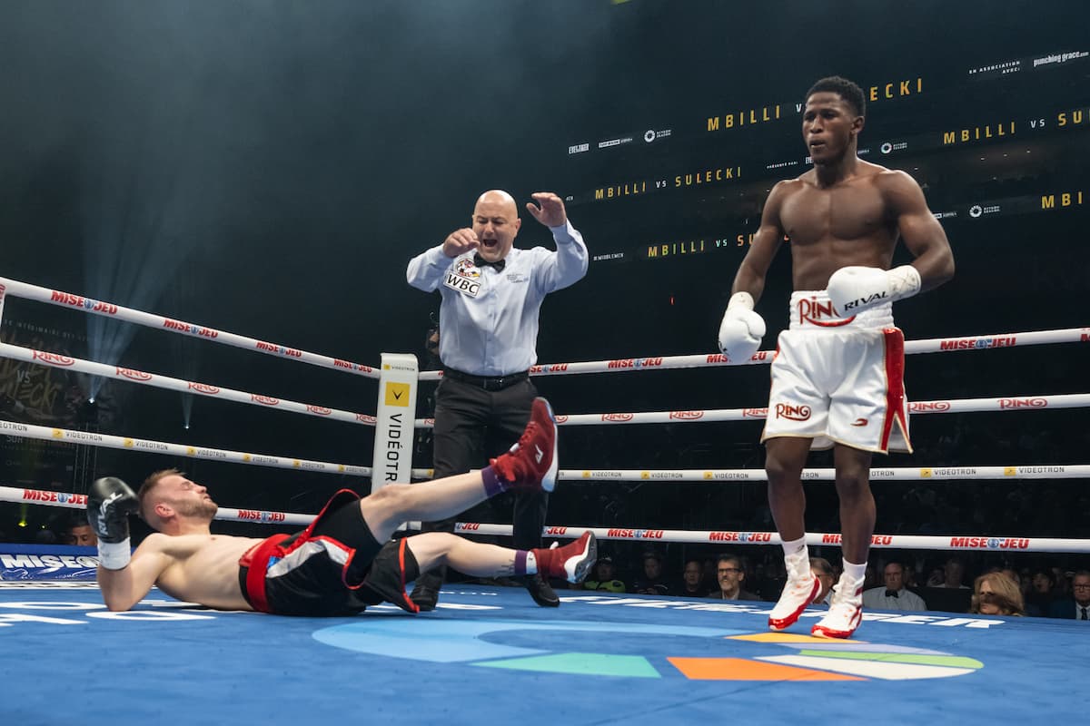 Jhon Orobio knocks down Zsolt Osadan during their boxing bout in Québec City, Canada