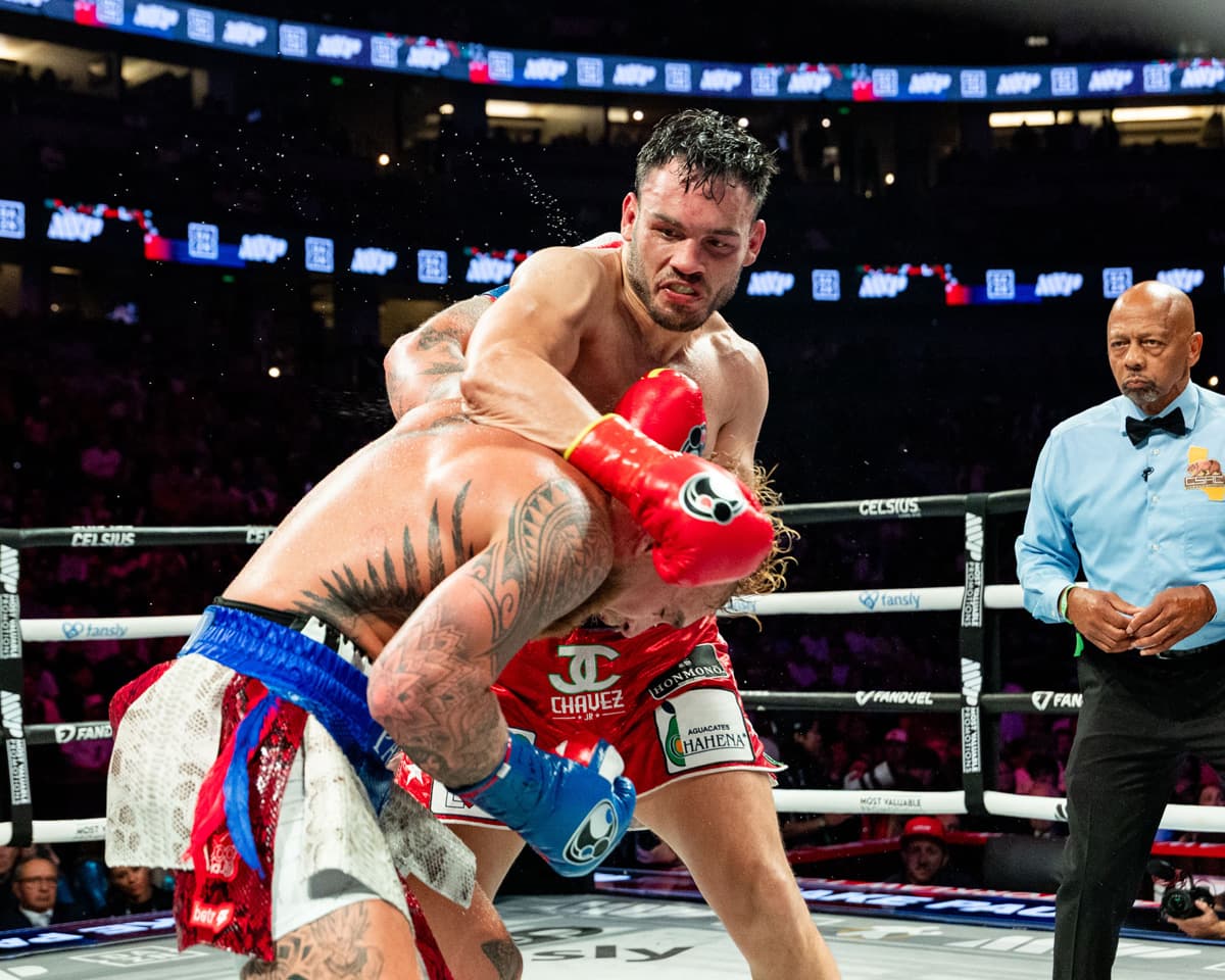 Julio Cesar Chavez Jr attacks Jake Paul during their bout in Anaheim, CA