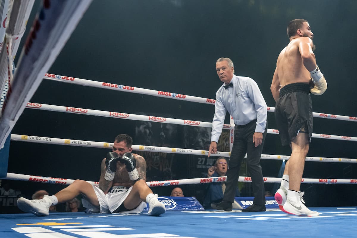Luis Santana knocks down Eduardo Estela during their boxing bout in Québec City, Canada