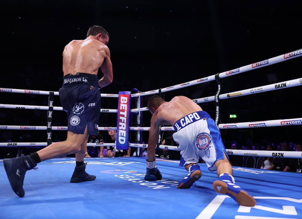 Peter McGrail knocks down Ionut Baluta during their boxing bout in Birmingham, England