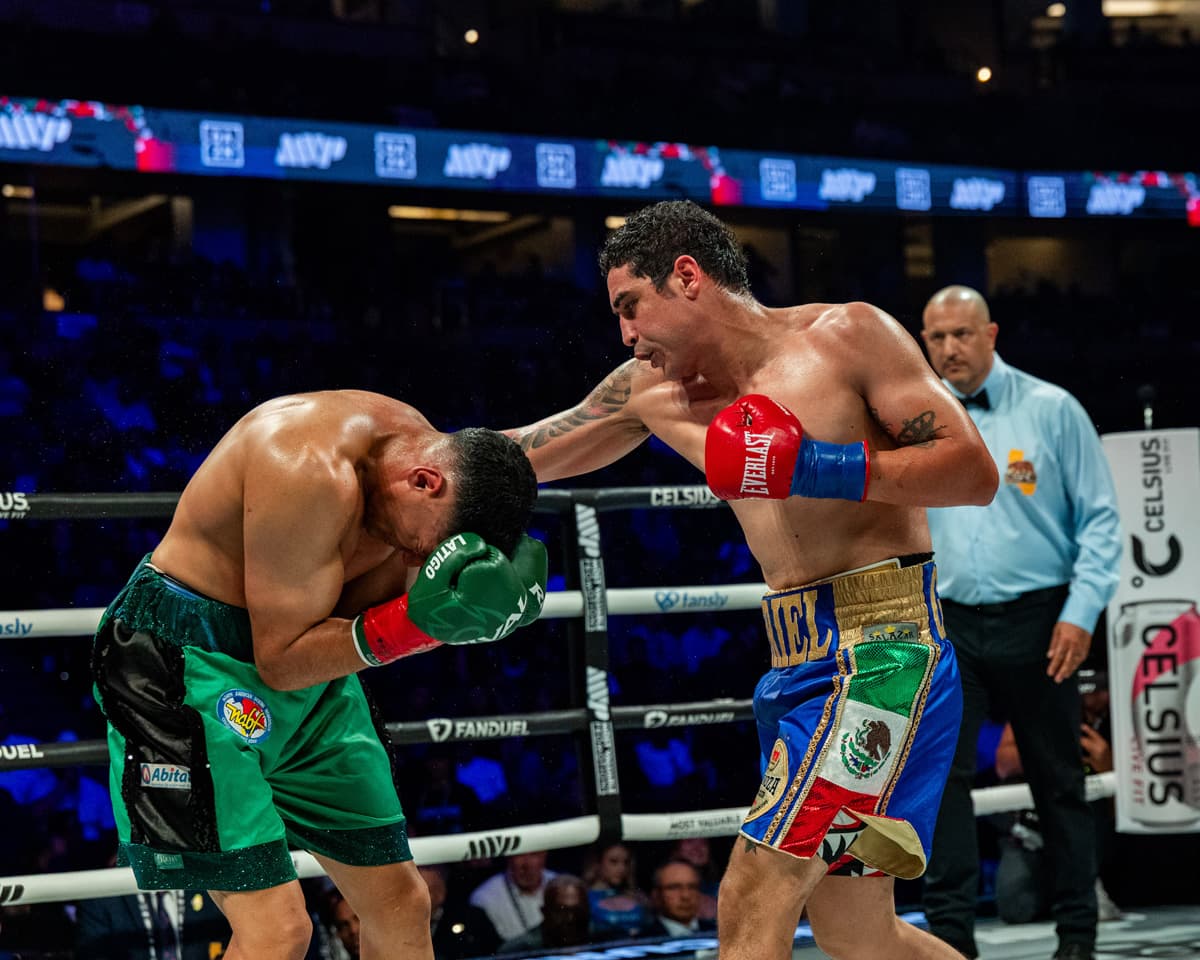 Raul Curiel punches Victor Ezequiel Rodriguez during their bout in Anaheim, CA
