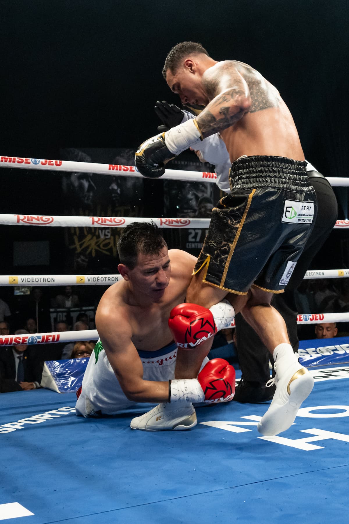 Steven Butler knocks down Jose De Jesus Macias during their boxing bout in Québec City, Canada