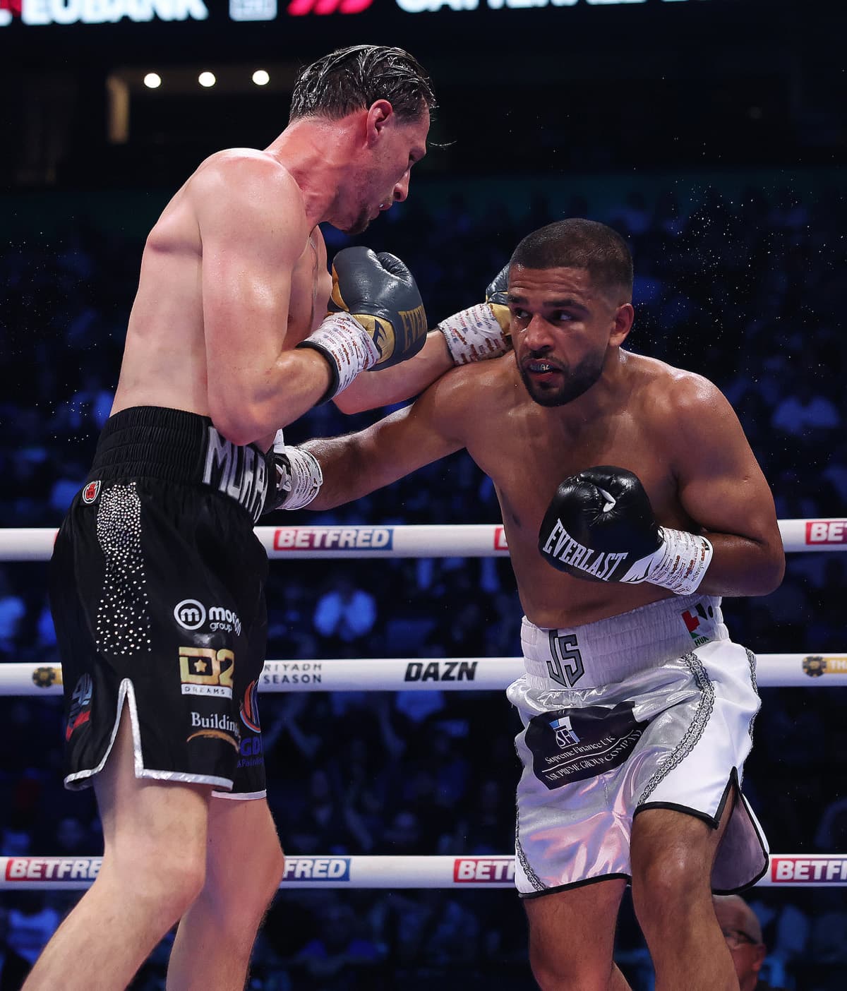 Aqib Fiaz punches Alex Murphy during their boxing bout in Manchester
