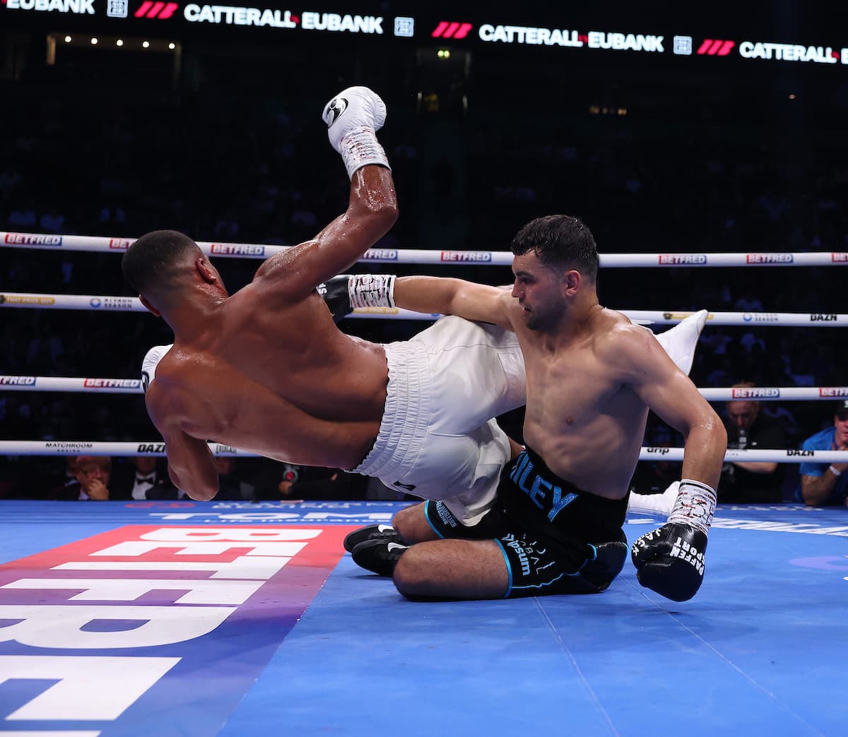 Jack Catterall and Harlem Eubank fall during their boxing bout in Manchester
