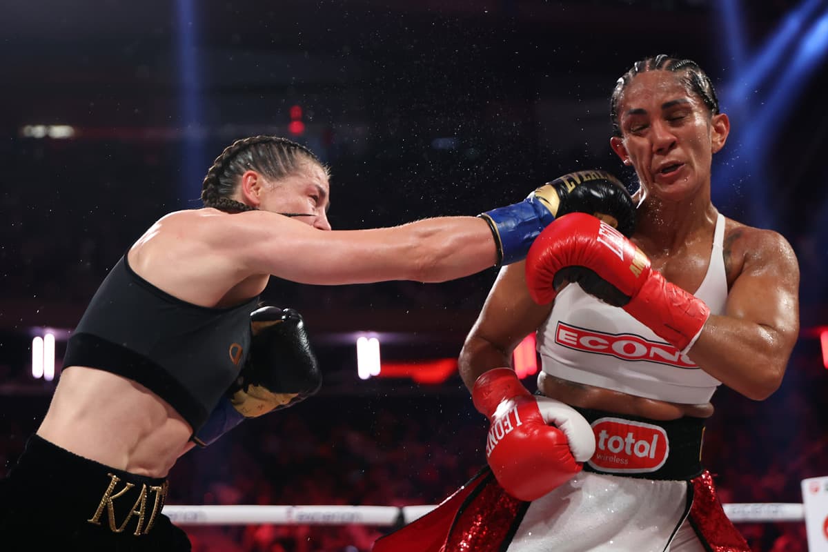 Katie Taylor punches Amanda Serrano during their boxing bout at MSG in New York