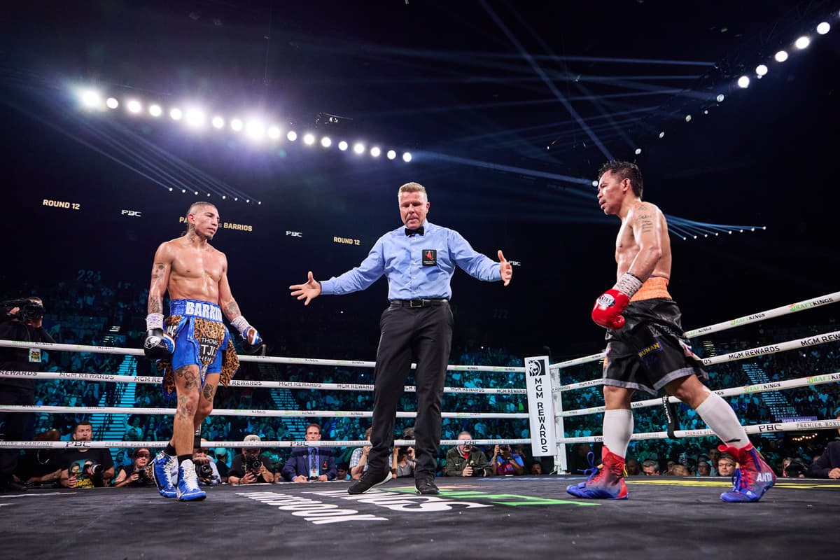 Referee Tom Taylor instructs Mario Barrios and Manny Pacquiao during their bout at the MGM Grand Garden Arena in Las Vegas