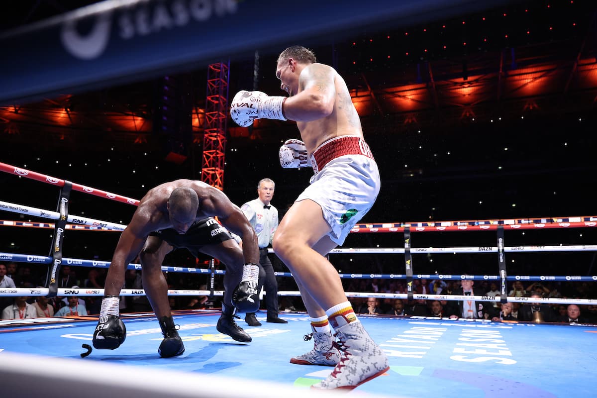 Oleksandr Usyk knocks down Daniel Dubois during their boxing bout at Wembley Stadium in London