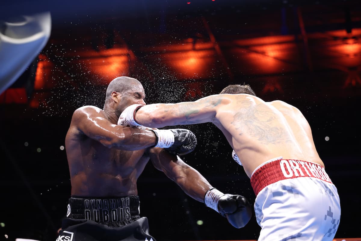 Oleksandr Usyk punches Daniel Dubois during their boxing bout at Wembley Stadium in London