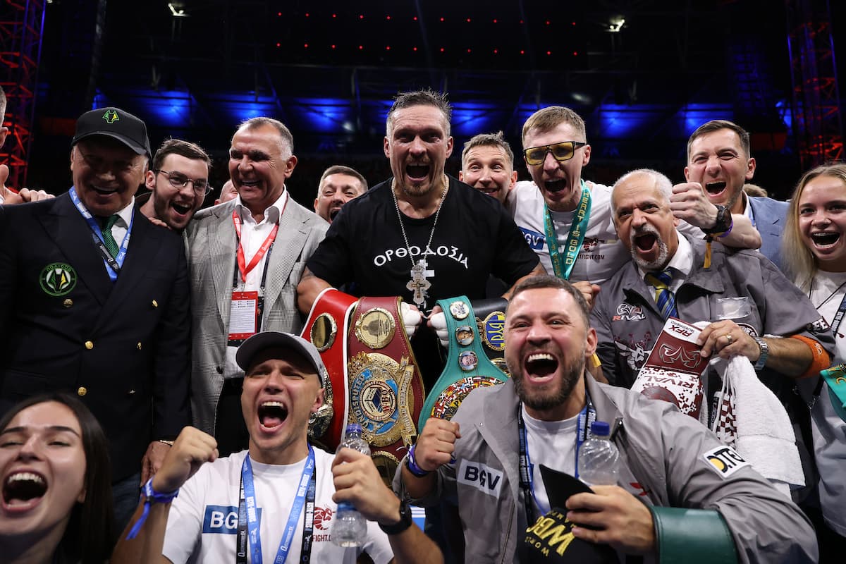 Oleksandr Usyk with his team after his victory over Daniel Dubois at Wembley Stadium in London