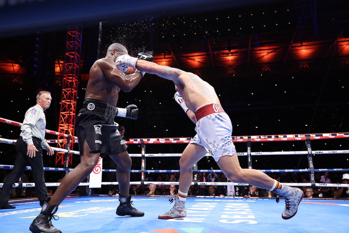 Oleksandr Usyk punches Daniel Dubois during their boxing bout at Wembley Stadium in London