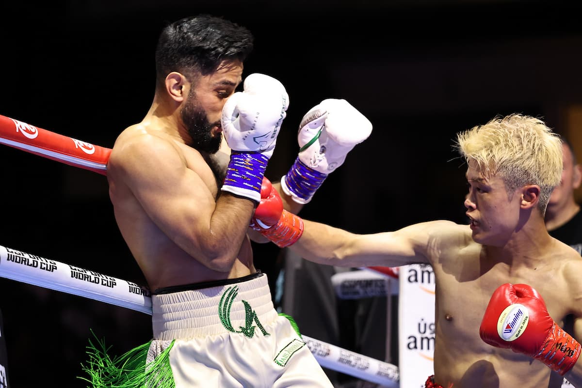 Hayato Tsutsumi punches Qais Ashfaq during their boxing bout