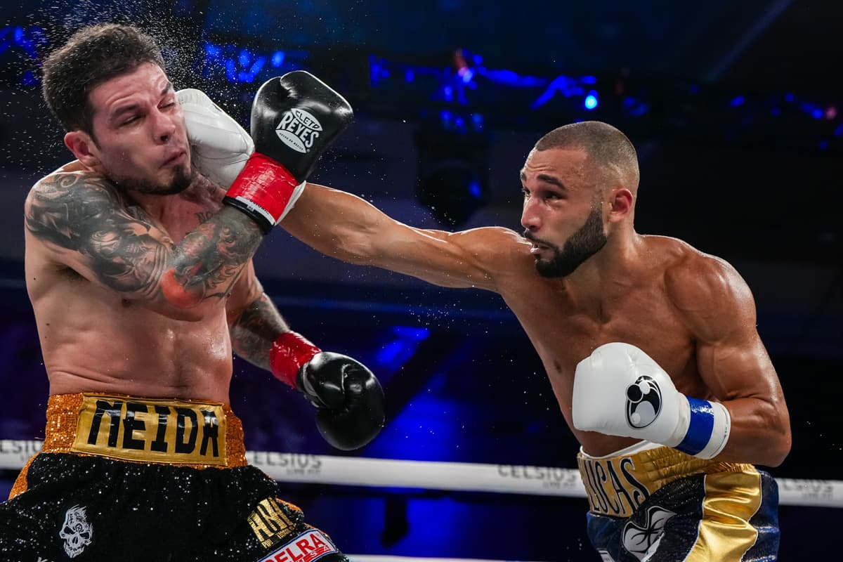 Lucas Bahdi punches Roger Gutierrez during their boxing bout at Caribe Royale Orlando