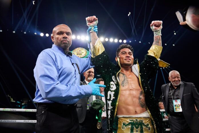 Referee raising Mark Magsayo's hand after victory at MGM Grand Garden Arena