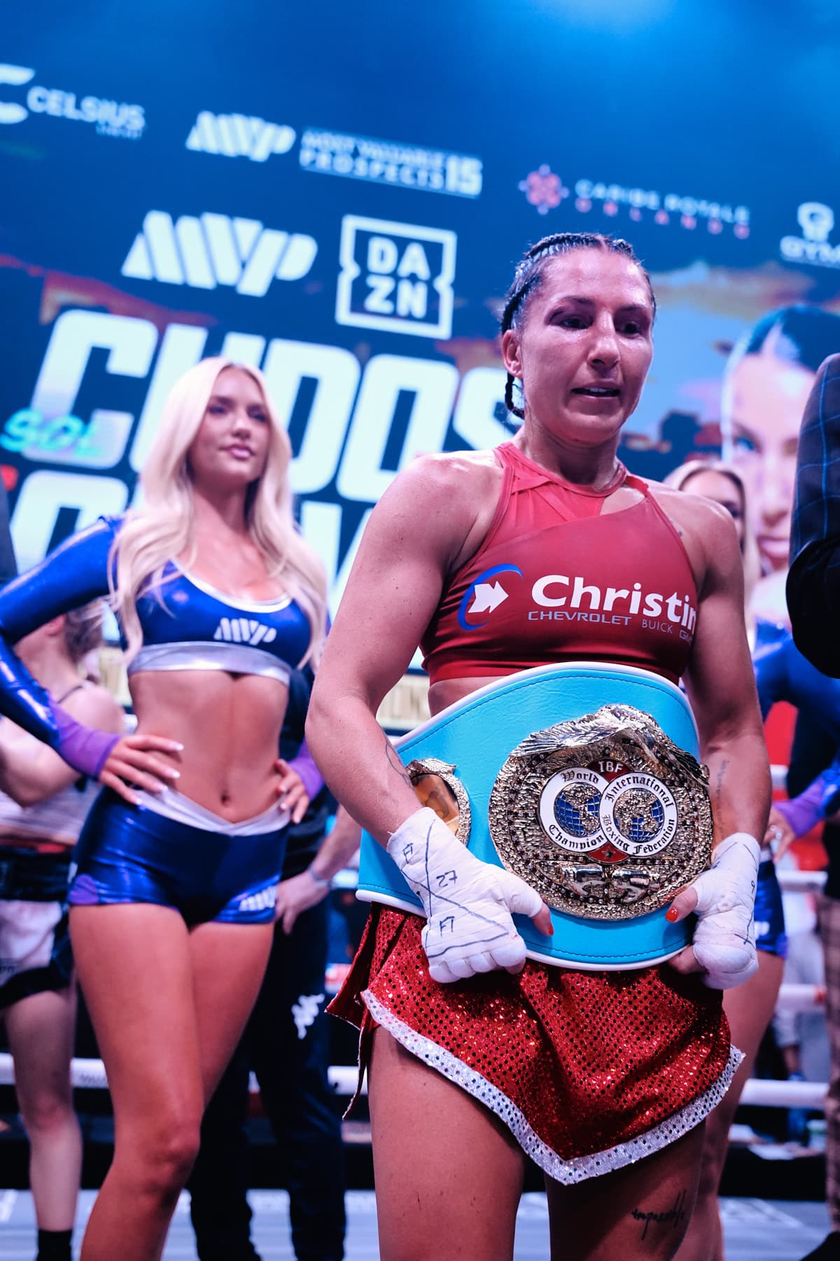 Kim Clavel with her championship belt following victory