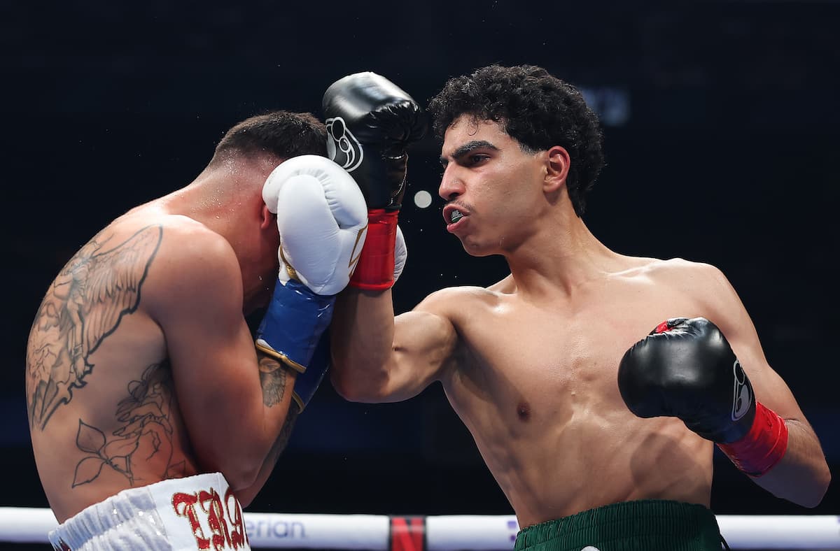 Mohammed Alakel throws an uppercut during his boxing bout against Travis Crawford